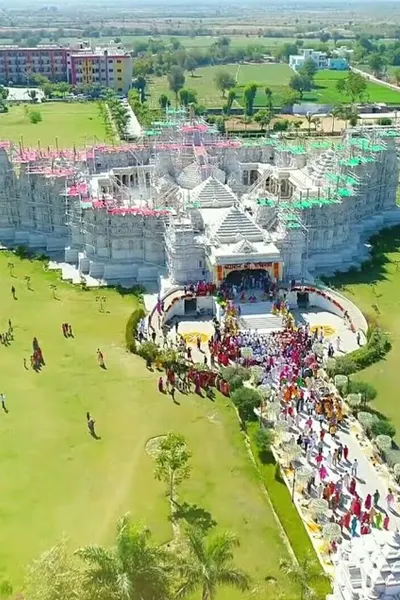 Aerial view of the grand Jain temple in Bhinmal surrounded by pilgrims, a popular religious site accessible from Abu Road.