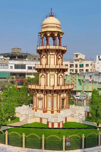 The ornate tower of Palanpur, showcasing the intricate architecture in a bustling city setting, a cultural landmark on the route from Abu Road.